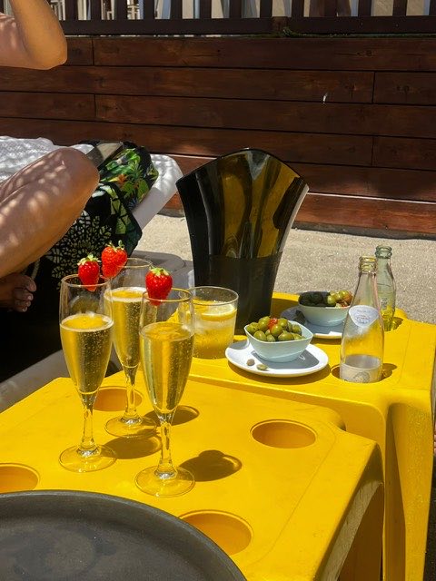 Glasses of cava and snacks on a yellow table