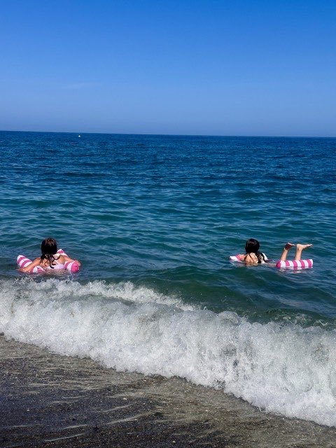 Swimmers on inflatable rings in the sea
