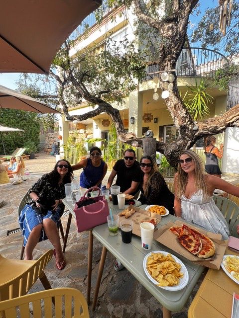 Members sharing pizza at a long table