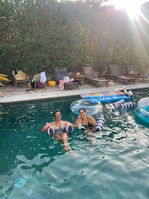 Guests on floats in the pool in the evening sun